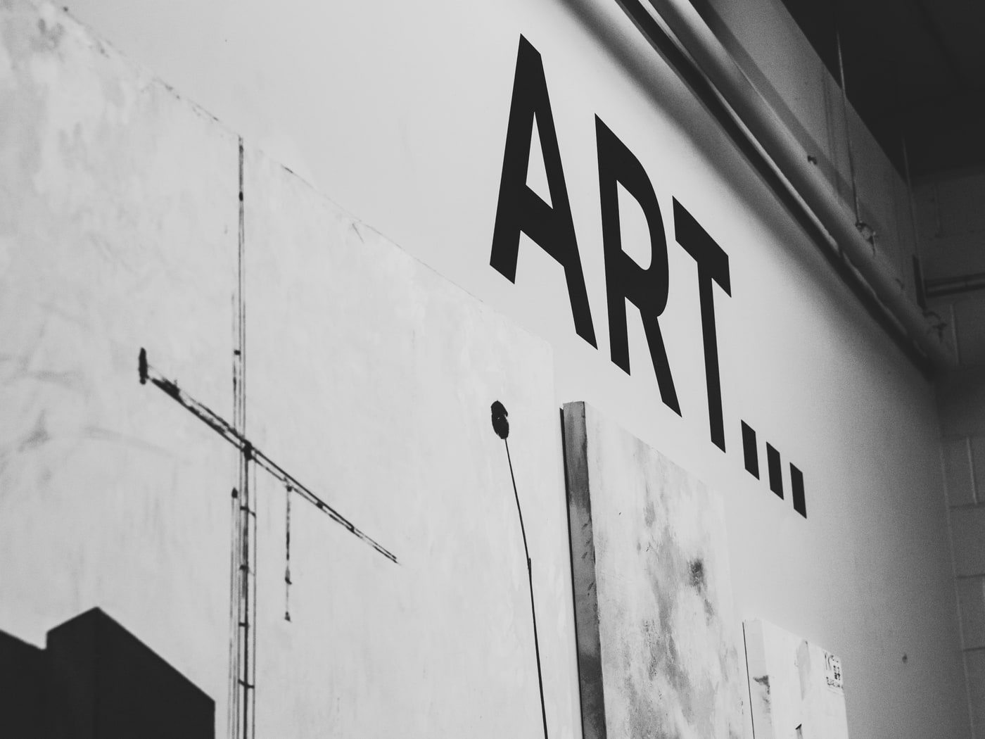 A studio wall lettered with the word art, seen at an angle